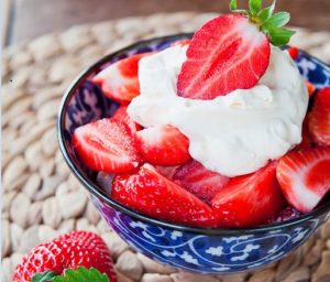 A bowl of strawberries and cream