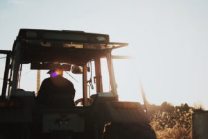 A tractor plowing through a field
