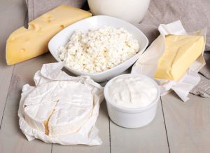 Cheese blocks and spread sitting on a table.